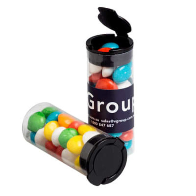 A transparent flip lid tube filled with colourful chewy fruit sweets, featuring a branding label on the side.