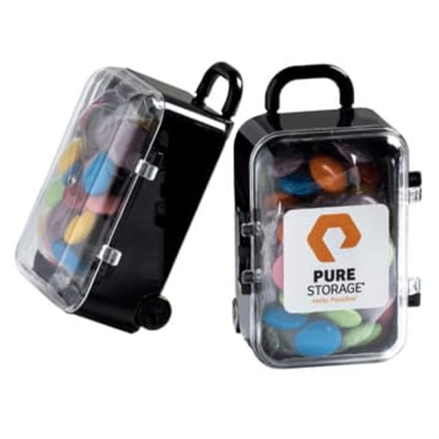 A carry-on case with a handle, featuring colourful choc beans inside and a logo on the front.