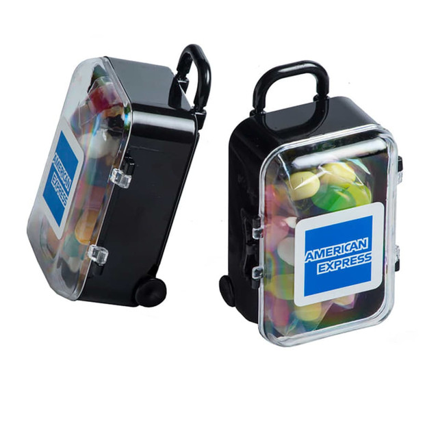 A black carry-on case filled with a variety of colourful JELLY BELLY jelly beans, featuring a handle and wheels.