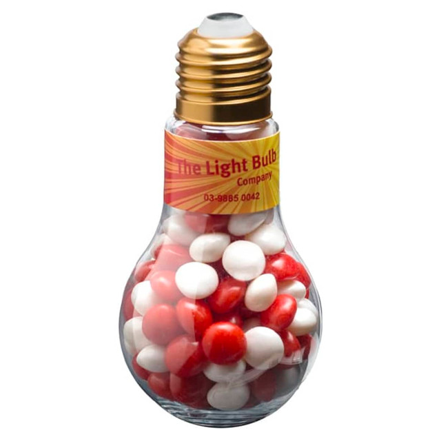 A light bulb-shaped container filled with red and white chewy fruits, featuring a gold top and a label.
