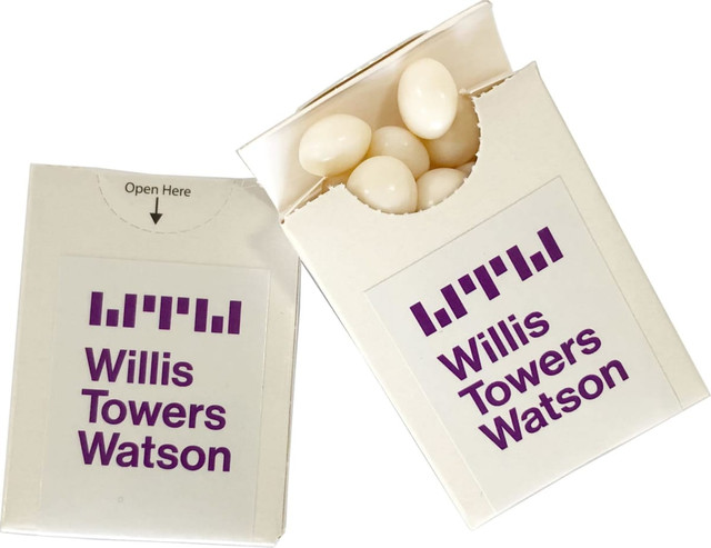 A white cardboard box with a flip lid, containing chewy white mints. The box features a logo.
