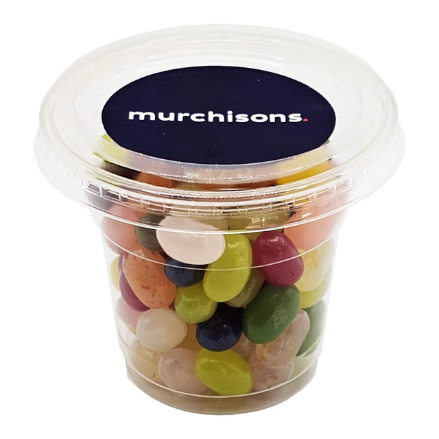 A clear tub filled with multicoloured jelly beans, featuring a label with branding.