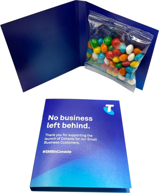 A blue promotional card with a bag of multi-coloured chewy fruit candies inside. The card features a logo.