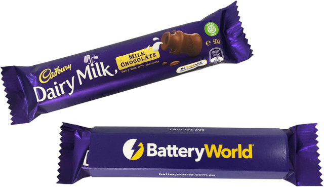A Dairy Milk chocolate bar, wrapped in purple packaging, featuring milk chocolate. Includes a branding logo.