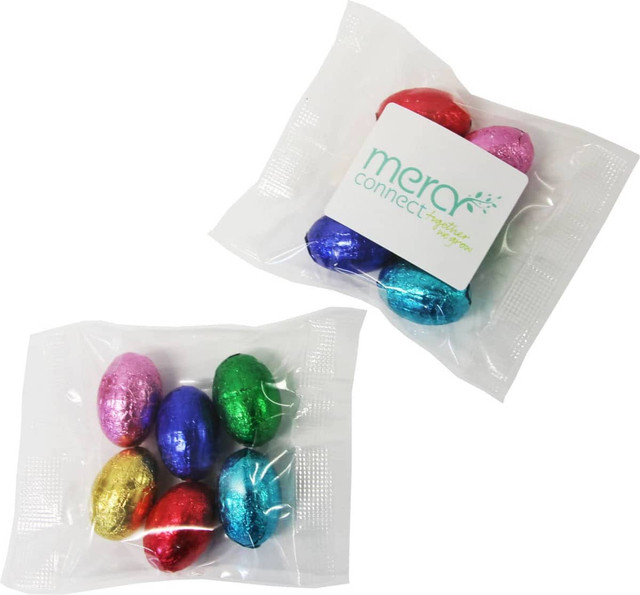 A bag containing six mini solid Easter eggs in various colours: pink, blue, green, red, and gold.