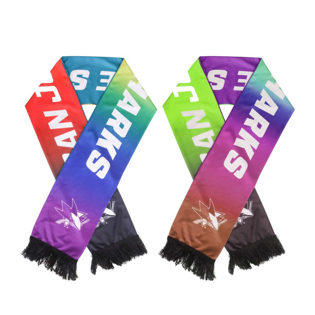 A colourful fabric scarf featuring a gradient design in red, green, purple, and black, with fringed ends and a logo.