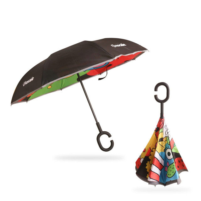 A reversible folding umbrella in black and multicoloured patterns, featuring a hook handle and a compact folded design.
