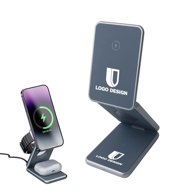 A grey foldable wireless charger stand with a smartphone and earbuds charging on it. It features a logo design.