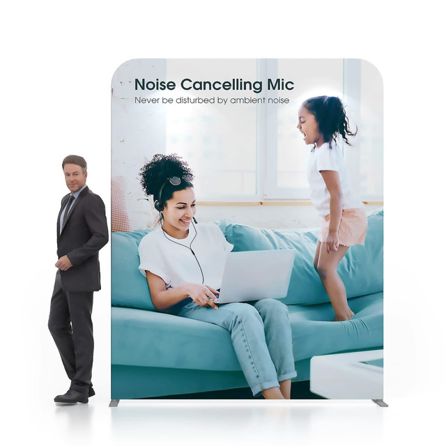 A 2m straight tension fabric display wall featuring a woman using a laptop on a sofa, with a child playing nearby.
