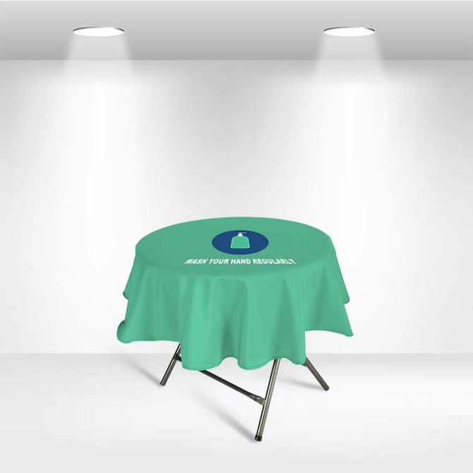 A round table cover in light green with a logo, featuring a message about hand washing.
