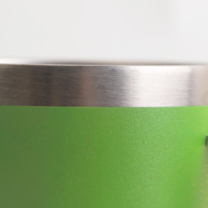 A green stainless steel mug featuring a metallic rim and a smooth surface. It includes a logo.