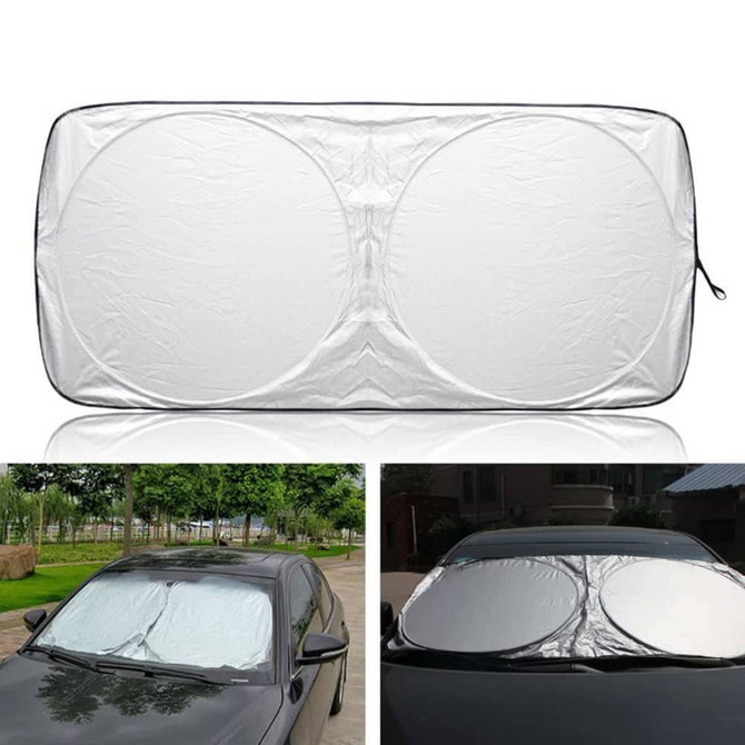 A foldable car shade in silver, featuring a circular design, displayed on a car windshield. It has a logo.