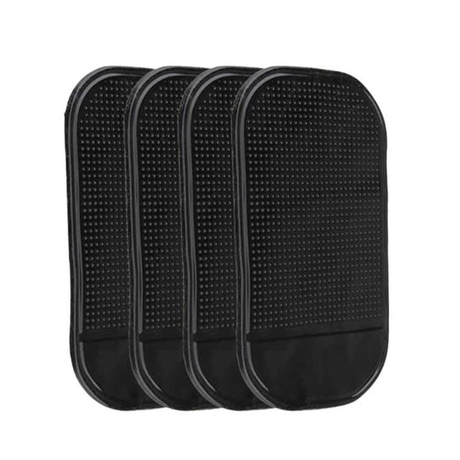 A set of four black dashboard mats with a textured surface. Each mat features a smooth border.