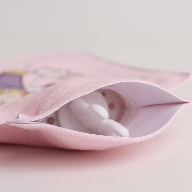 A hot water bottle in white, nestled inside a pink plush cover featuring a cute design.