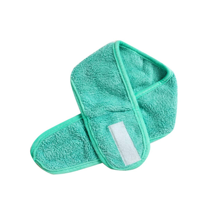 A green promotional headband made of soft, fluffy material with a velcro fastening.
