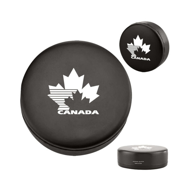 A black hockey puck shape stress reliever featuring a white maple leaf design and a logo.