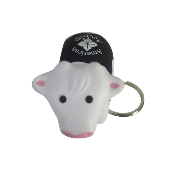 A cow-shaped stress reliever keyring in white, black, and pink, featuring a logo on top.