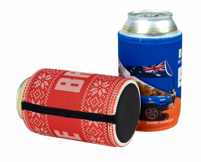 A red and white patterned can cooler alongside a blue can cooler featuring an Australian flag design. Both hold cans.