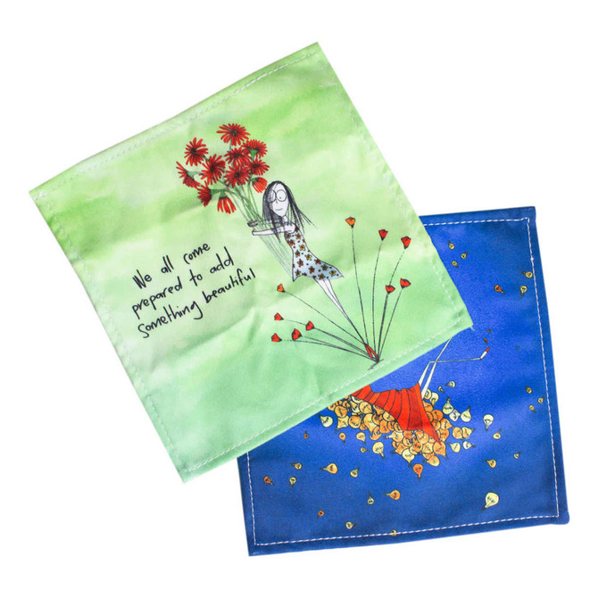 Two lens cloths featuring vibrant colours, one with a green background and floral design, the other in blue with an artistic illustration.