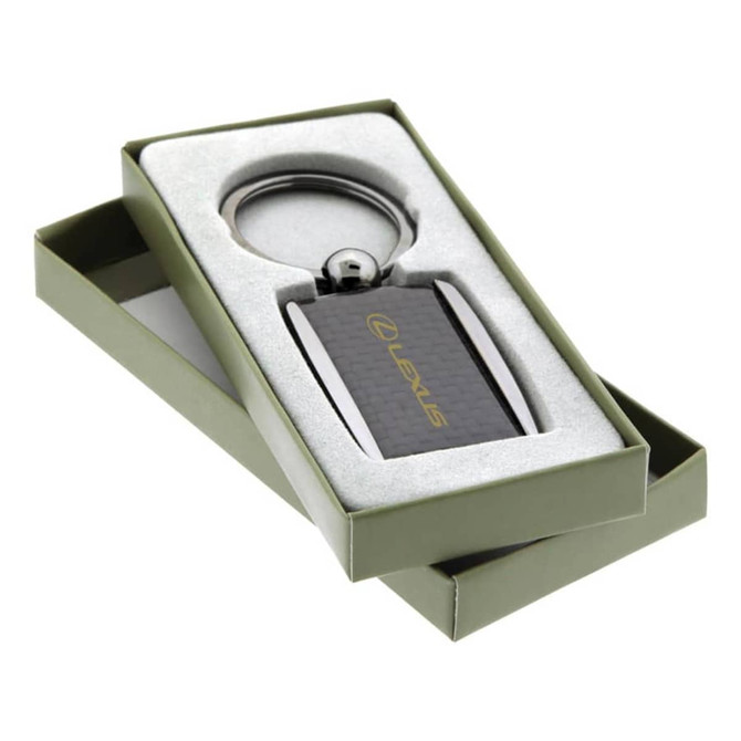 A sleek carbon fibre keychain in a gift box, featuring a branding logo and metallic accents.