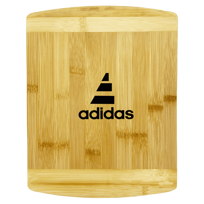 A bamboo cutting board featuring a sleek design with a logo. The board has a natural finish with a smooth surface.