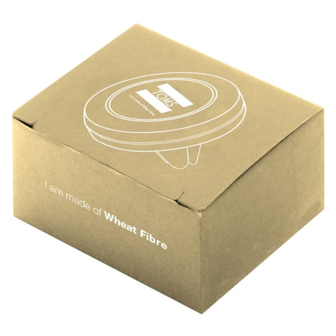 A round, silver car vent mount in a box made of wheat fibre, featuring a logo on the top.