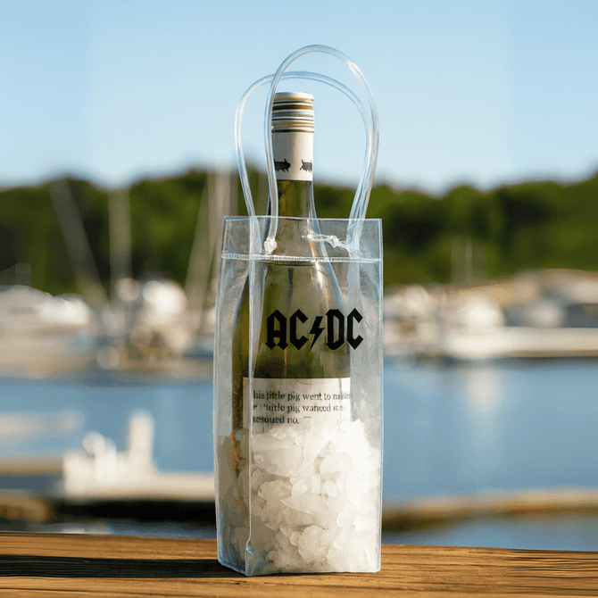 A clear cooler bag with a drink bottle, filled with ice, featuring a logo and sturdy handles.