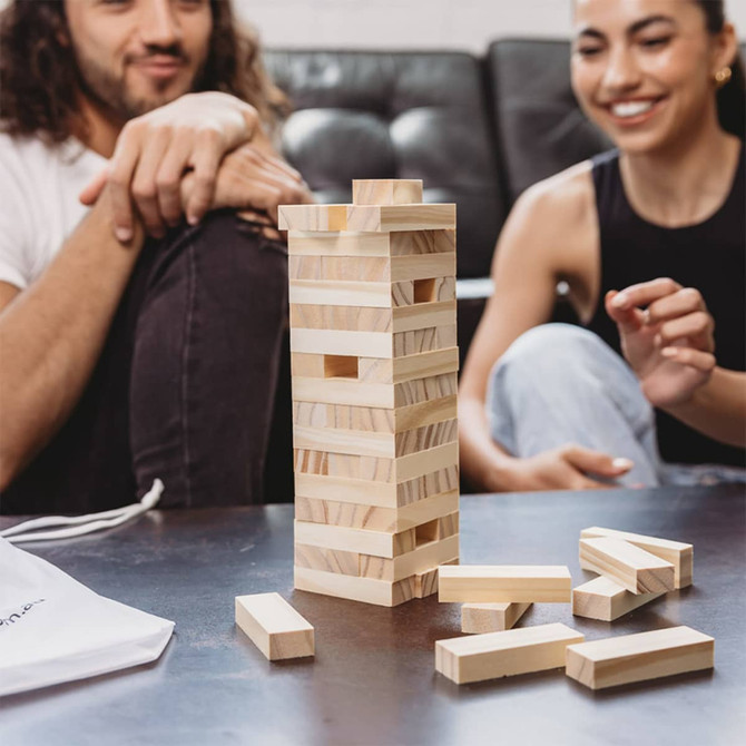 A stacking puzzle set in natural wood colour, featuring a pouch and several loose blocks on a table.