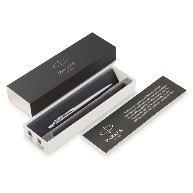 A metal ballpoint pen in brushed stainless steel, presented in a black box with a white interior and a branded card.