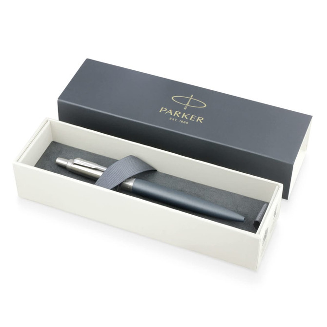 A matte grey ballpoint pen displayed in a white box with a black interior, featuring a logo.