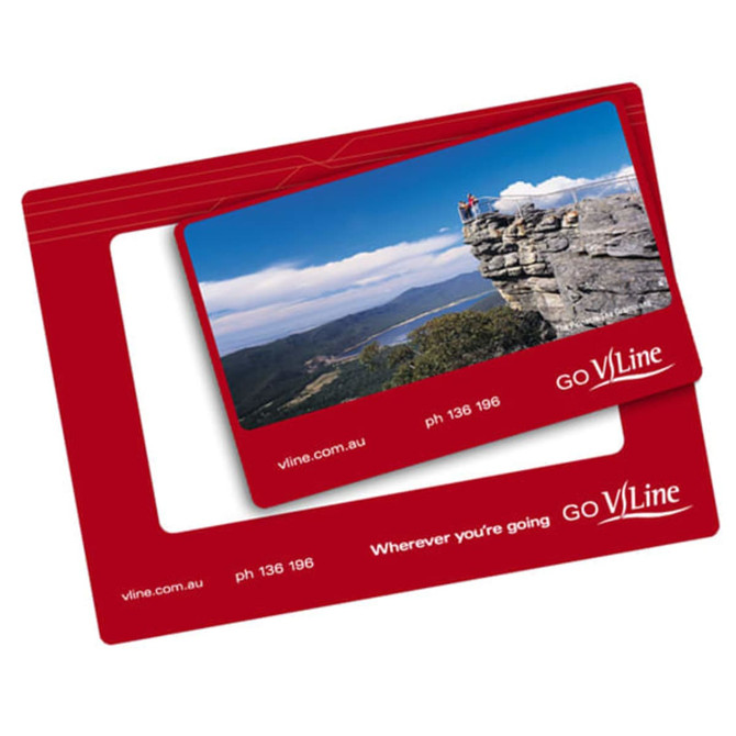 A red magnetic photo frame featuring a scenic landscape image and a logo. It has a slot for a photo.