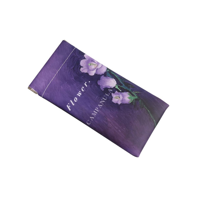 A purple glasses pouch featuring floral artwork and a logo, suitable for storing eyewear or accessories.