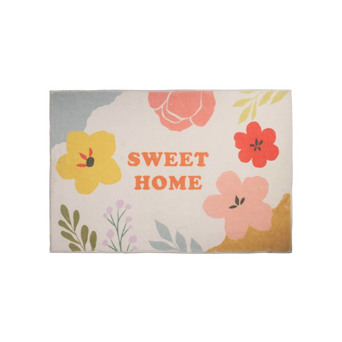 A floral plush logo mat in pastel colours featuring various flowers and the phrase "SWEET HOME."