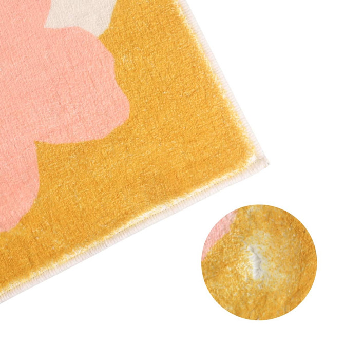 A plush logo mat featuring a vibrant design with pink and yellow colours, highlighting a soft texture and detailed edges.