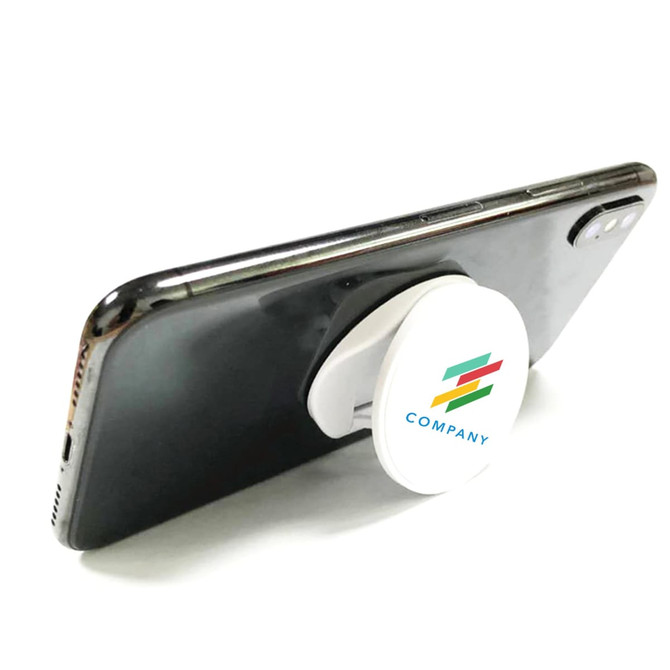 A round white phone holder attached to a smartphone, featuring a logo in multiple colours.