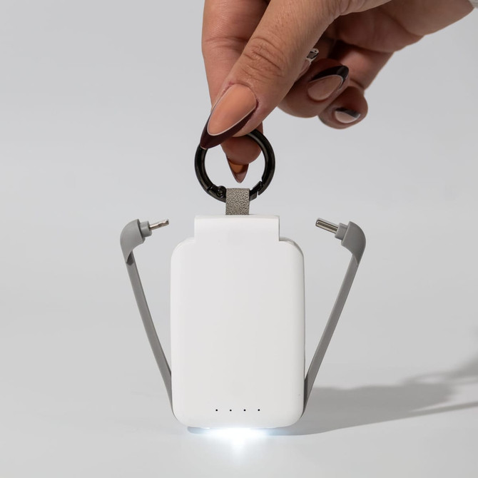 A white Thorfinn 2,000mAh mini power bank with grey accents and a keyring attachment, illuminated by a light.