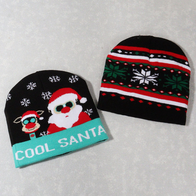 Two knitted beanies, one featuring a Santa design in red, white, and green, and the other with a festive pattern in black and red.