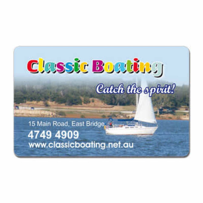 A rectangular fridge magnet with rounded corners featuring a sailing scene and a vibrant logo at the top.