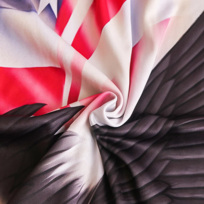 A vibrant car seat cover featuring a mix of red, white, and black, with intricate wing designs and a flag pattern.