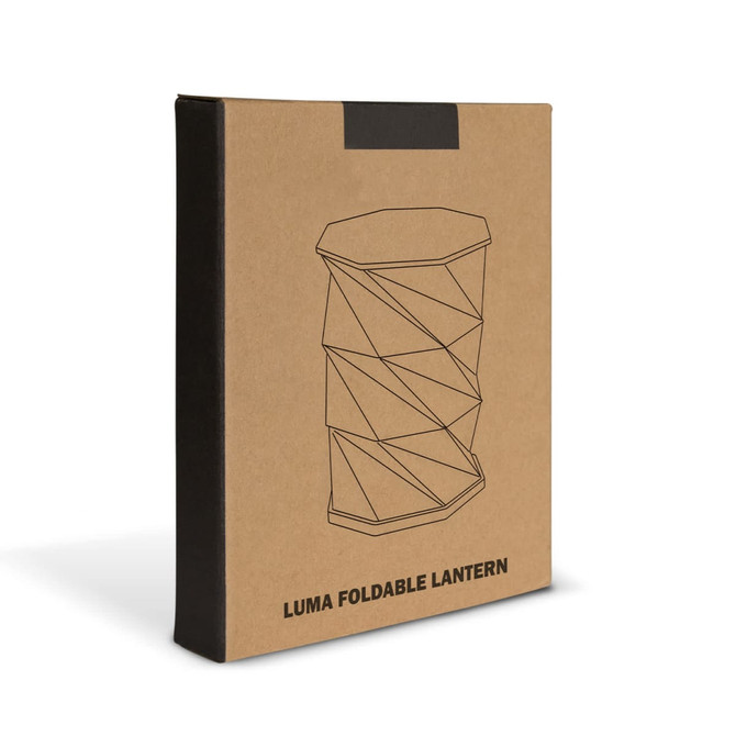 A beige box featuring an illustration of a foldable lantern with a geometric design. The box has a logo.