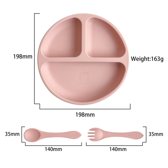 A silicone kids suction plate in soft pink with three compartments, accompanied by a matching spoon and fork.