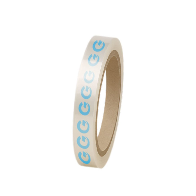 A roll of clear BOPP packing tape featuring a repeat blue logo pattern. The tape has a brown core.