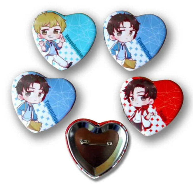 Four heart-shaped button badges featuring colourful characters, with a silver backing and a pin attachment.