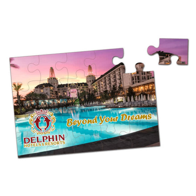 A jigsaw puzzle featuring a scenic hotel pool at sunset, with vibrant colours and a logo in the corner.