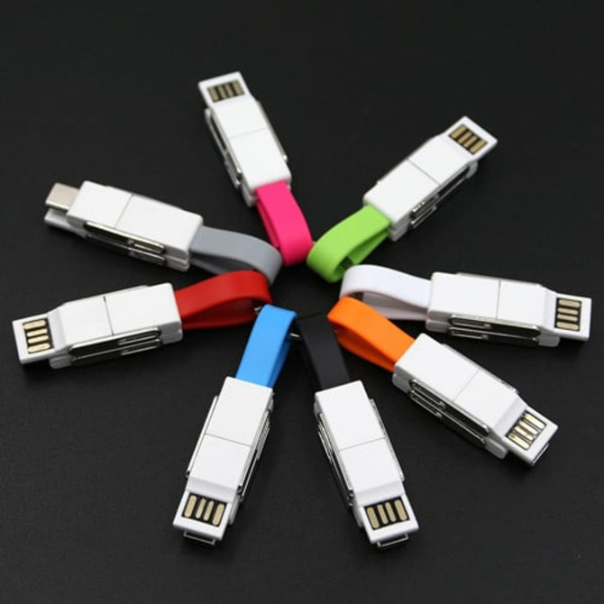 A collection of eight 4-in-1 USB cables in various colours including pink, red, blue, green, grey, and white, with a logo.