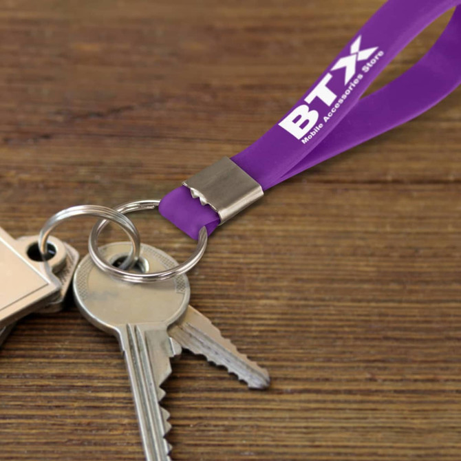 A purple silicone key ring attached to metal keys, featuring a logo on the ring.
