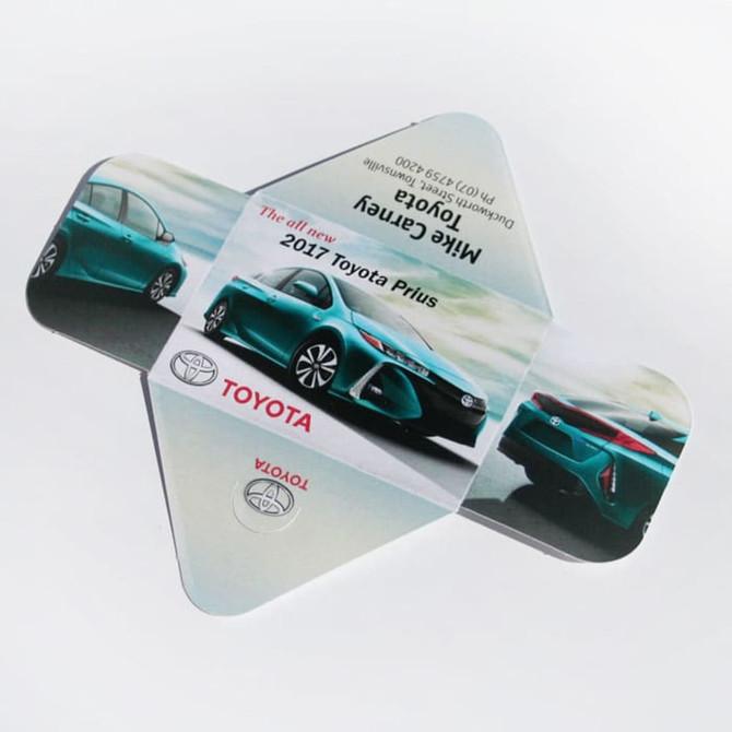 A triangular promotional folder featuring a blue Toyota Prius image, with a logo on one side.