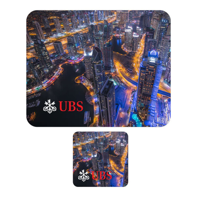 A large blue and black mouse mat with a city skyline design and a smaller matching coaster, both featuring a logo.