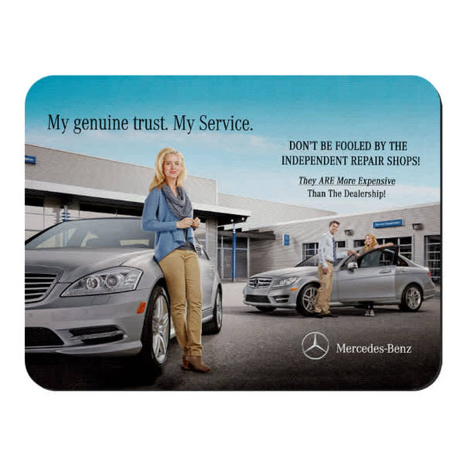A mouse mat featuring a grey car, a woman posing outdoors, and a logo. The background shows a dealership setting.