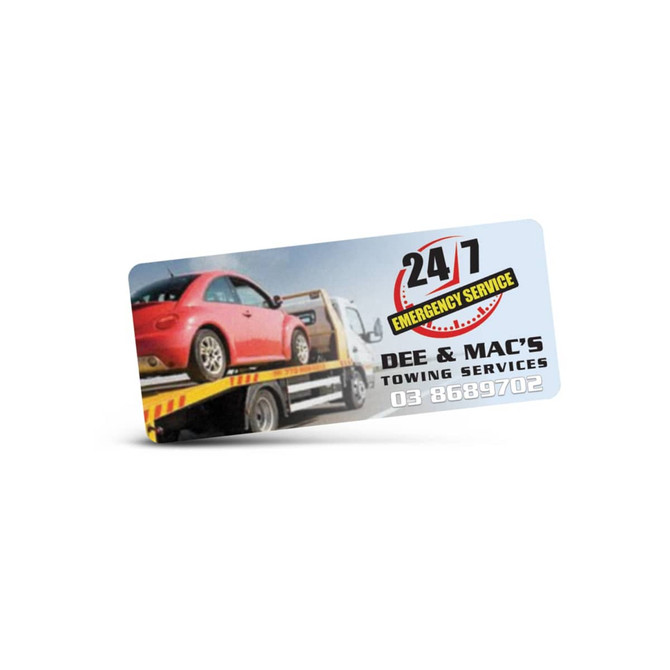 A rectangular promotional sticker featuring a towing service image, predominantly in shades of blue and red, with a logo.
